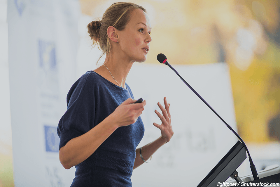 Woman speaking into a microphone