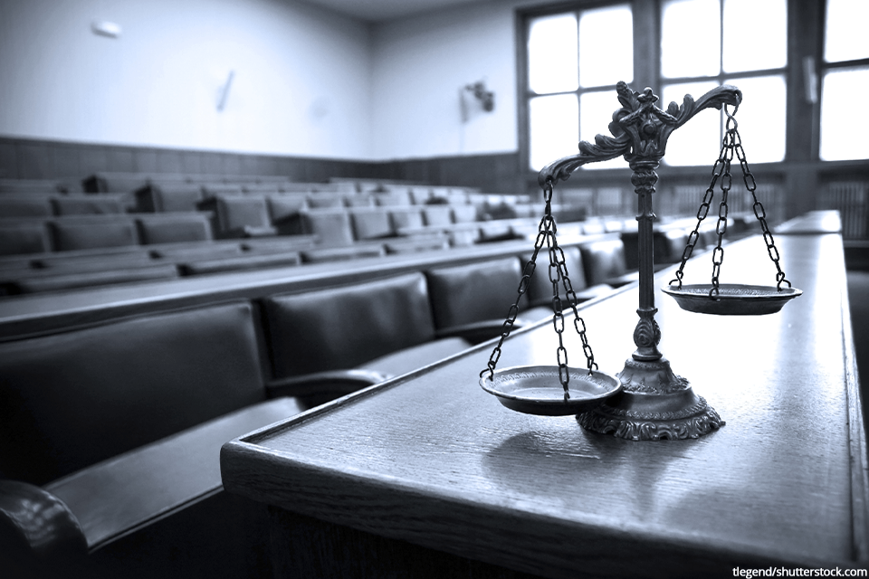 a courtroom with the scales of justice on a table