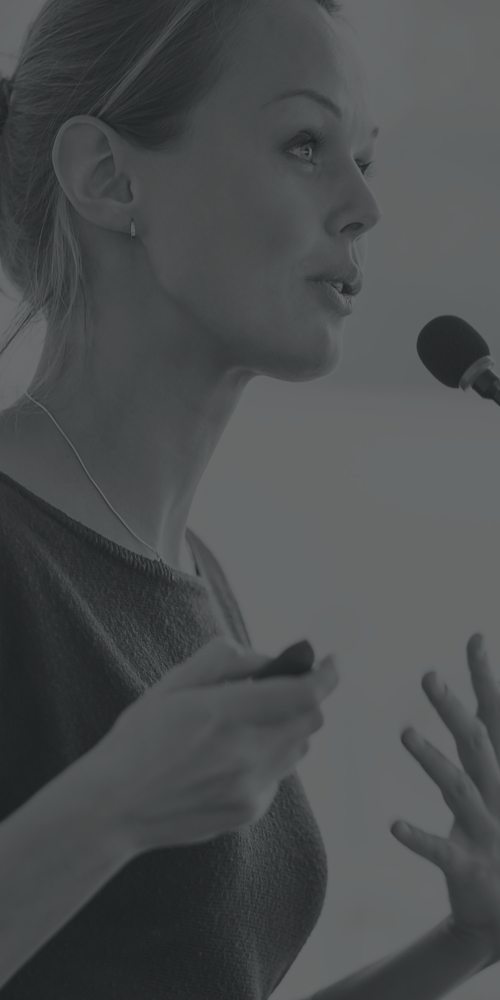 a woman speaking into a microphone