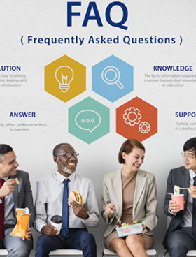 Office employees eating lunch and smiling. The words "Frequently Asked Questions" are displayed above them on the wall