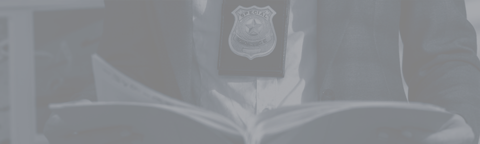 a person wearing a police officer badge and reading a book