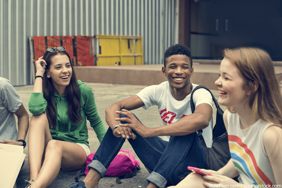 Group of teens hanging out and laughing