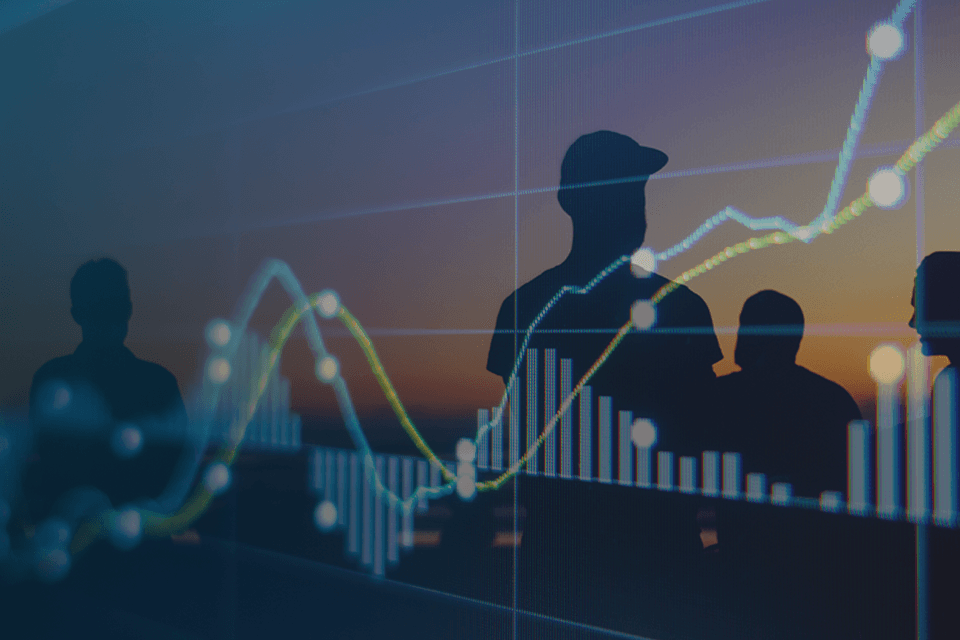 Silhouettes of people on beach with charts and graphs overtop of them 