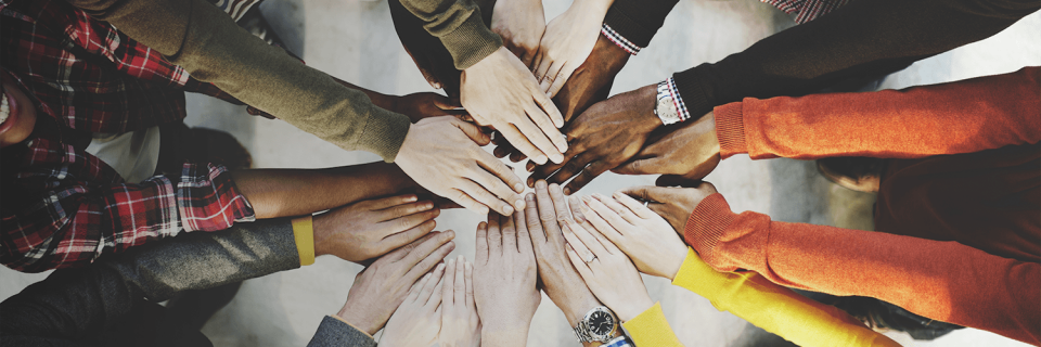 Group of people putting their hands together