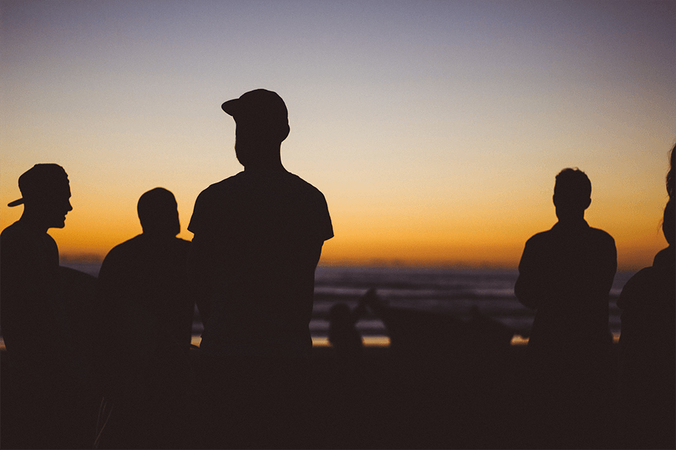 Silhouettes of men on the beach