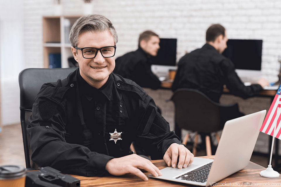 Police man sitting at a desk