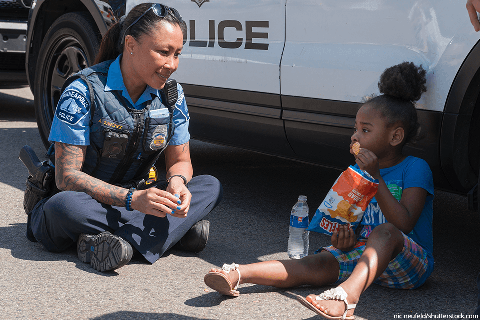 female police officer helping little girl