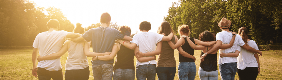 group of people walking arm in arm