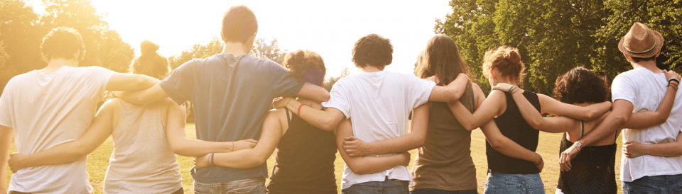 group of people walking arm in arm