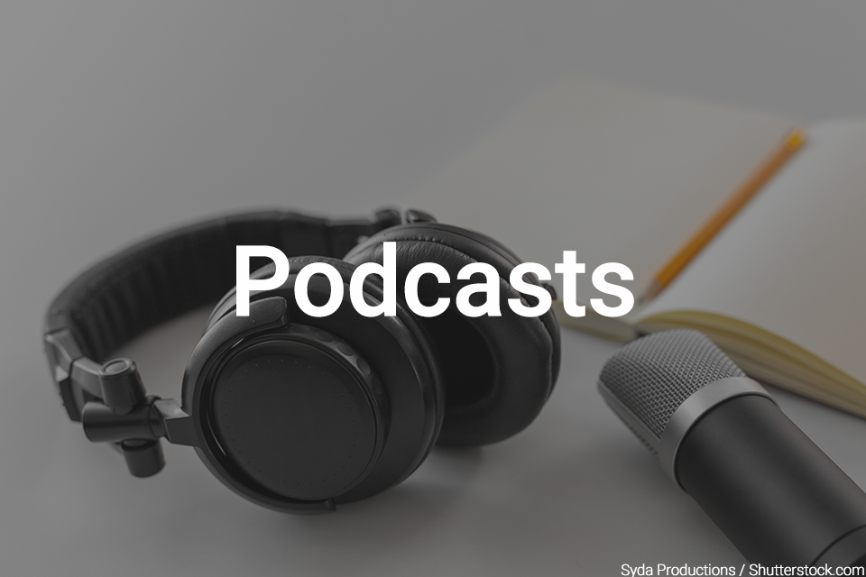 Photo of headphones, a microphone, and a book. Text says Podcasts overtop of photo