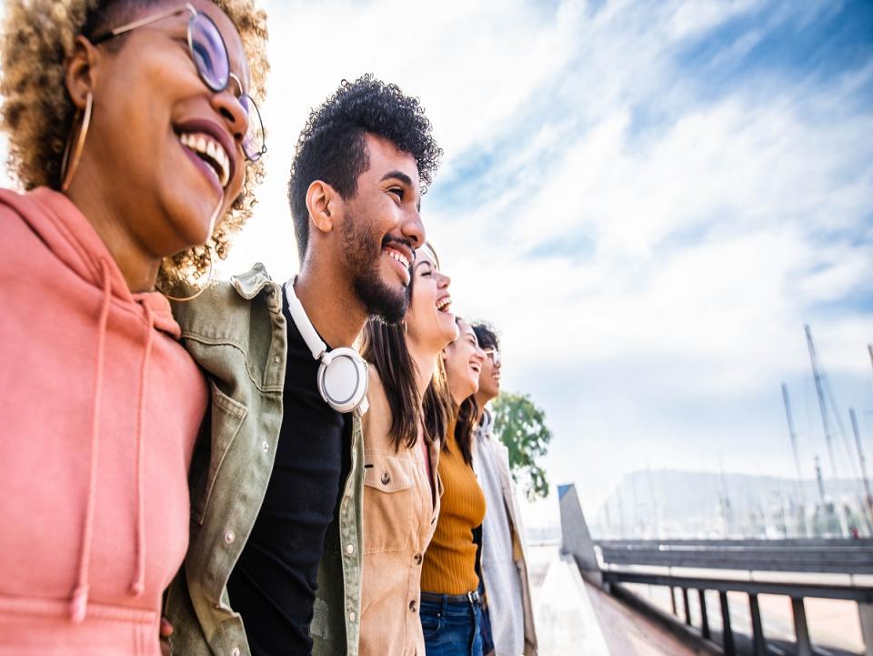 A group of young people look over a bridge