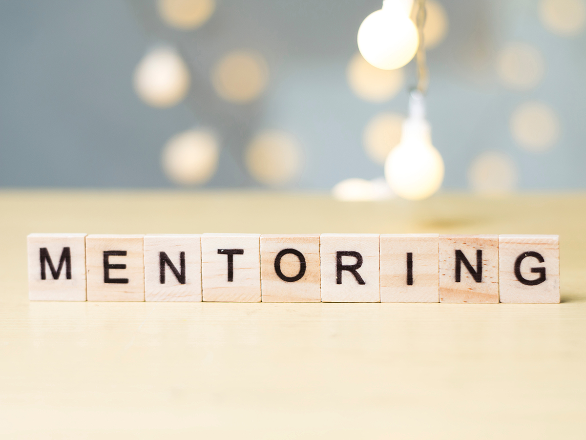 Scrabble Letter Pieces Spelling the word Mentoring