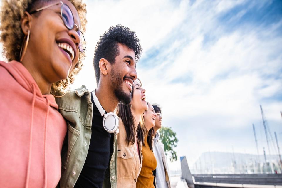 A group of young people look over a bridge