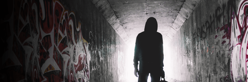 Scary silhouette of a man in a dark tunnel 