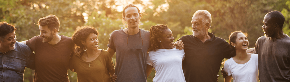 Diverse group of people with their arms around each other